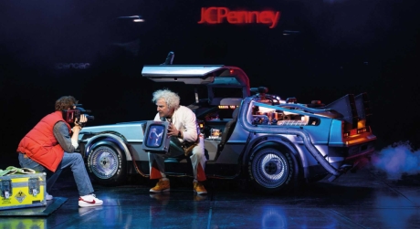 Marty McFly and Doc Brown sitting by the DeLorean in Back to the Future on stage